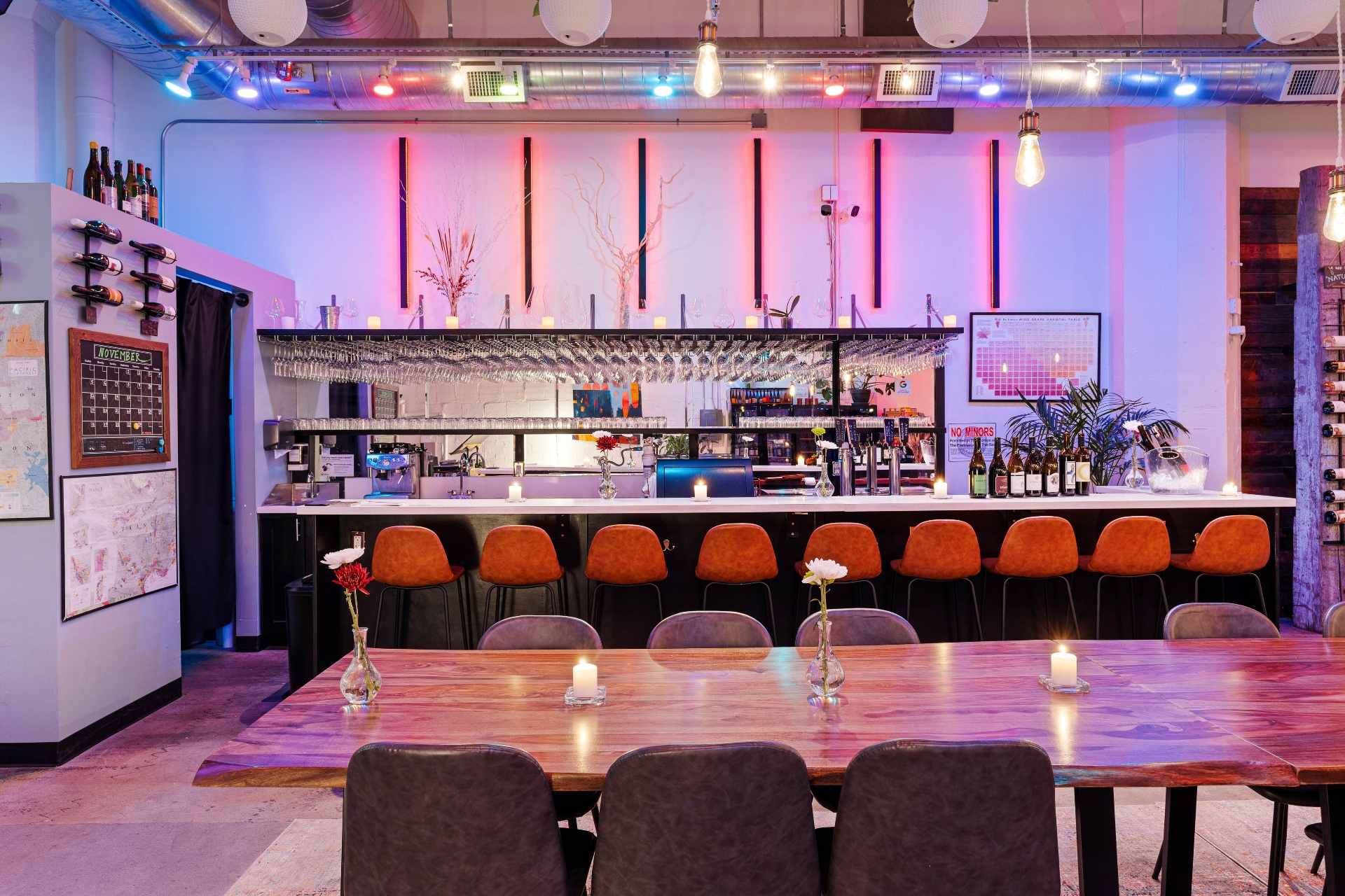 Bar with hanging stemware and warm neon backlight.