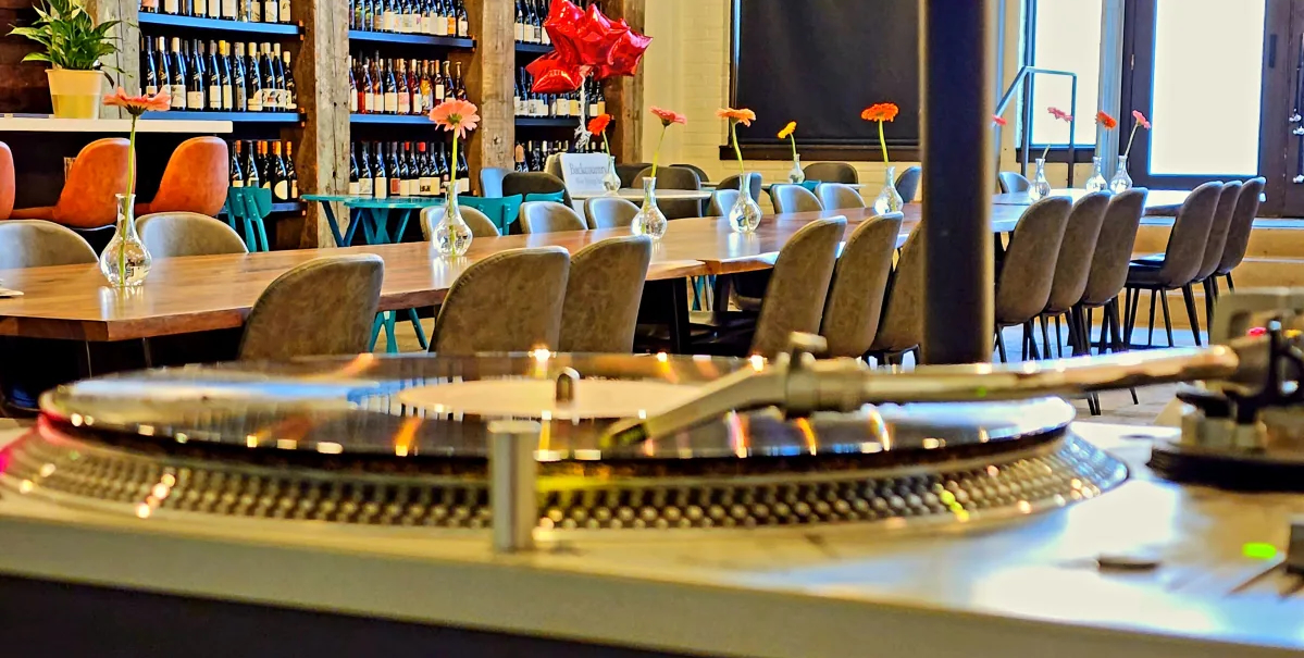A local DJ spinning vinyl on the turntable during Friday Night Flights at Backcountry Wine